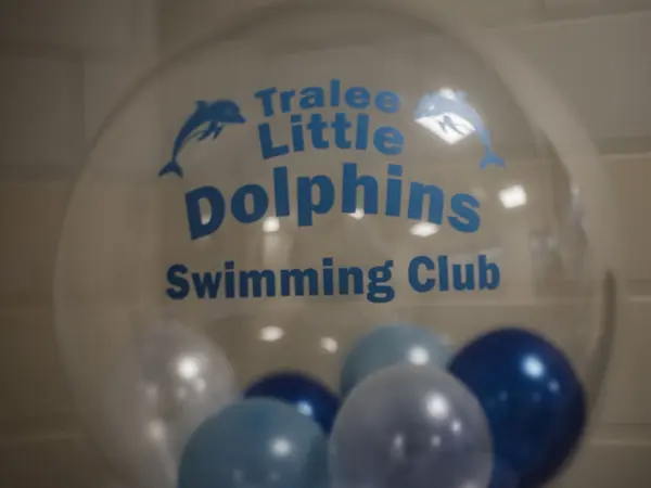 A clear balloon printed with the Tralee Little Dolphins Swimming Club name