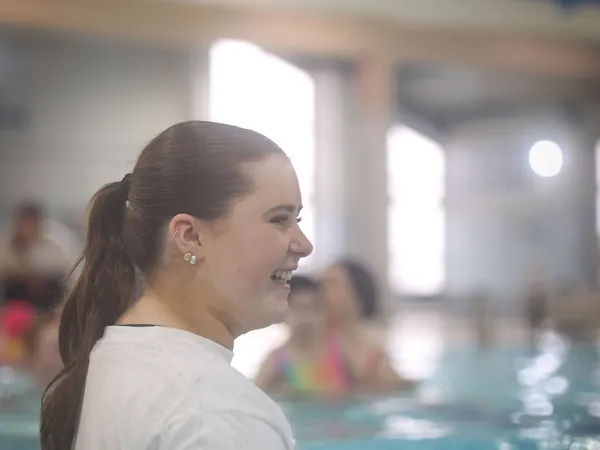 A smiling coach in the water during the Open Day session