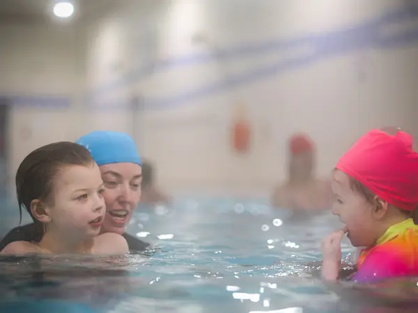 Children chatting happily together in the pool
