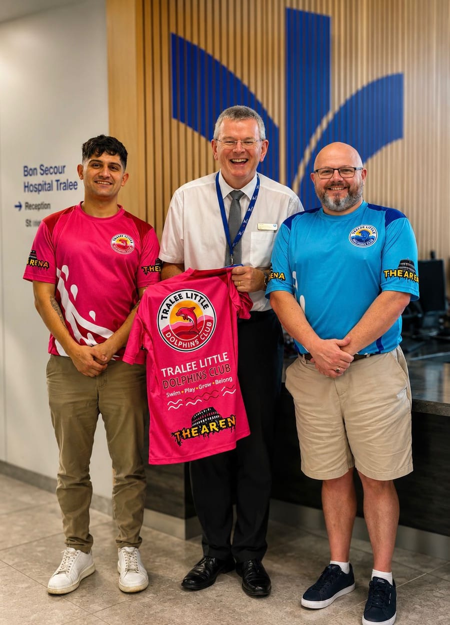 Shane Lee and Brian Casey presenting a pink Tralee Little Dolphins club shirt to Owen McCarthy at the Bon Secours Hospital Tralee reception