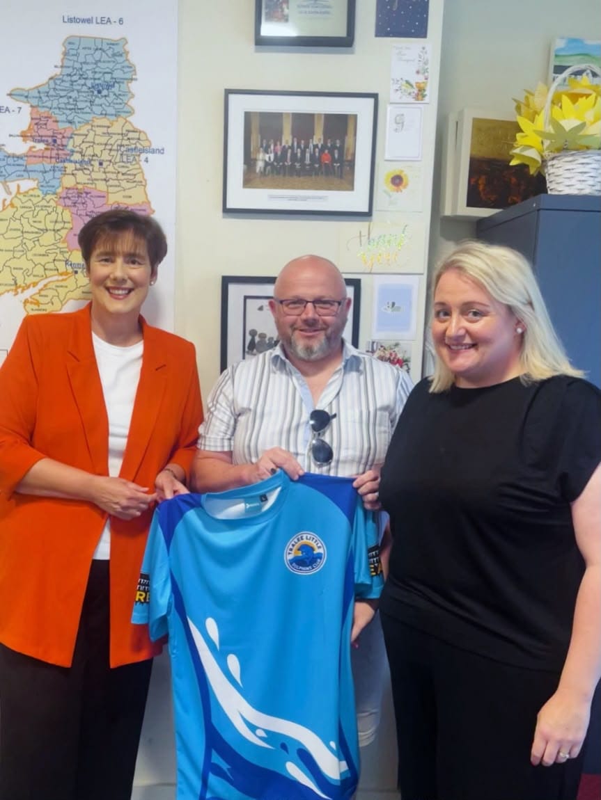 Brian and Jodie Casey presenting Minister Norma Foley with a Tralee Little Dolphins club shirt